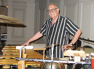Composer George Crumb surrounded by percussion instruments